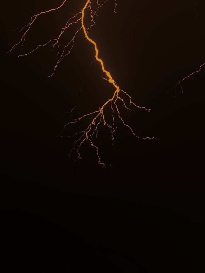 Powerful bolt of lightning striking the dark sky, capturing the raw energy of a thunderstorm.